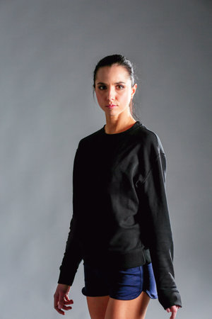 Portrait of a beautiful and healthy sport girl isolated on gray backgroundの写真素材