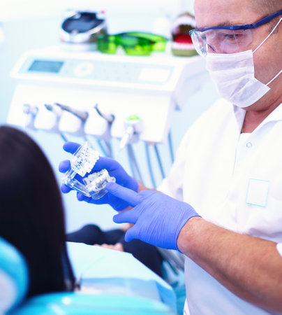 Portrait of a dentist who treats teeth of young woman patientの写真素材