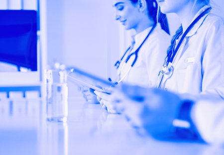 Doctors at the meeting, sitting on the deskの写真素材
