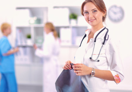 Portrait of woman doctor standing at hospitalの写真素材