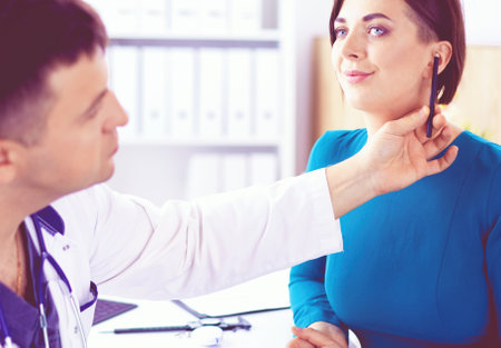 The patient and his doctor in medical officeの写真素材