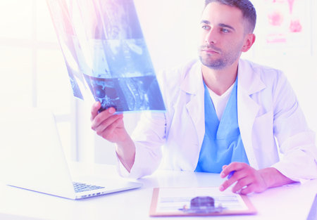 Handsome doctor is talking with young female patient and makingの写真素材