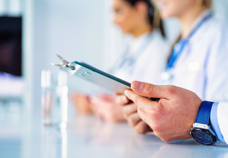 Doctors at the meeting, sitting on the deskの写真素材