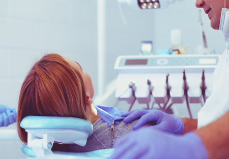 Detail of hand holding dental tools in dental clinic. Dentist Conceptの写真素材