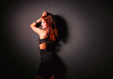 Beautiful woman with evening make-up in black dressの写真素材