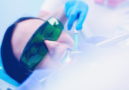 Dental team and patient at dentists surgeryの写真素材