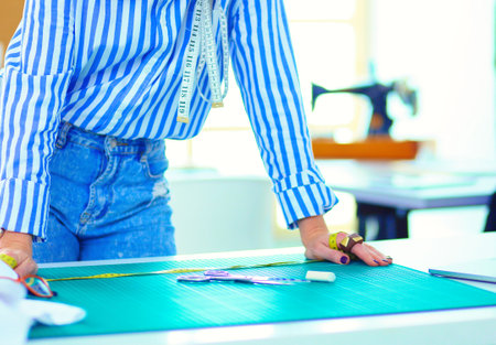 Fashion designer working on her designs in the studioの写真素材