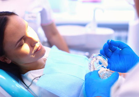 Portrait of a dentist who treats teeth of young woman patientの写真素材