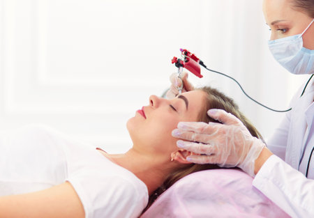 A young girl having red lips permanent makeup, micropigmentationの写真素材