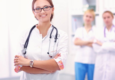 Portrait of woman doctor standing at hospitalの写真素材