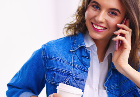 Young businesswoman talking on the phone in coffee shopの写真素材