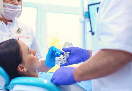 Portrait of a dentist who treats teeth of young woman patientの写真素材