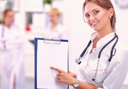 Portrait of woman doctor standing at hospitalの写真素材