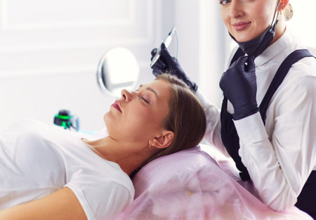 Microblading eyebrows work flow in a beauty salon.の写真素材