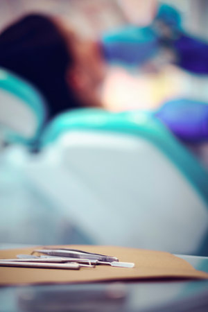 Metallic dentist tools close up on a dentist chairの写真素材