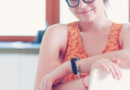 Young woman sitting a table in the kitchenの写真素材
