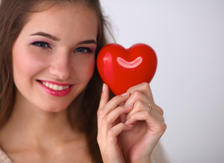 Portrait of beautiful happy woman holding a Valentine day symbol.の写真素材