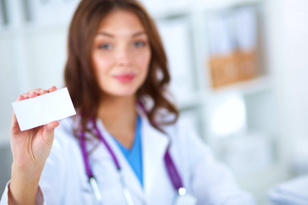 female doctor holding an empty card, isolated on whiteの写真素材