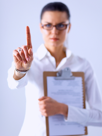 Woman touching an imaginary screen with her fingerの写真素材