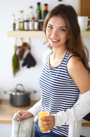 Portrait of a pretty woman holding glass with tasty juice .の写真素材