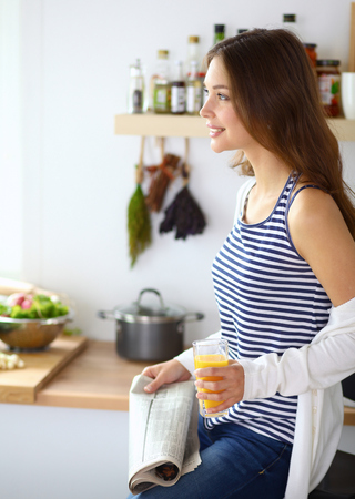Portrait of a pretty woman holding glass with tasty juiceの写真素材