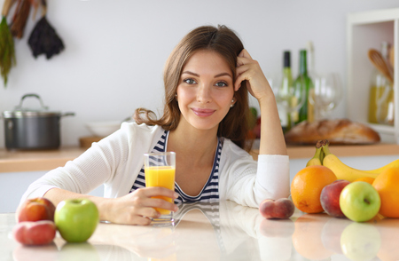 Portrait of a pretty woman holding glass with tasty juice Portrait of a pretty woman holding glass with tasty juice