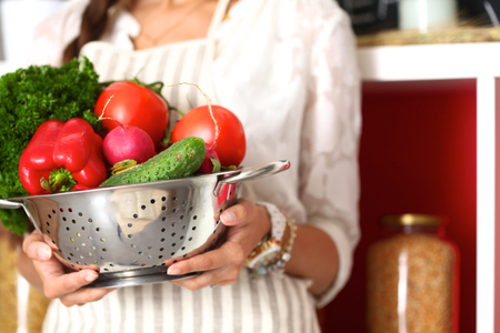 Young woman standing near desk in the kitchen .の写真素材