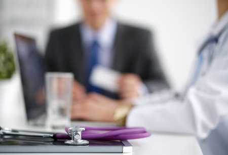 Medical team sitting at the table in modern hospital .の写真素材