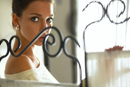 Portrait of a cute woman in sweater at home .の写真素材