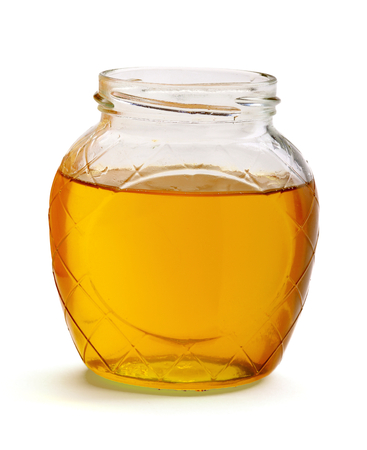 glass of fresh honey isolated on white backgroundの写真素材