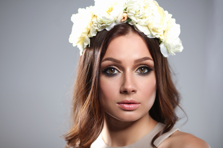 Portrait of a beautiful woman with flowers in her hair.の写真素材