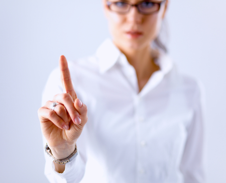 Woman touching an imaginary screen with her finger.の写真素材