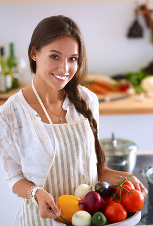 Young woman holding grocery shopping bag with vegetables .の写真素材