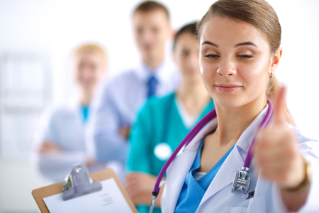 Young happy female doctor showing thumbs upの写真素材