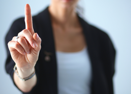 Woman touching an imaginary screen with her finger .の写真素材