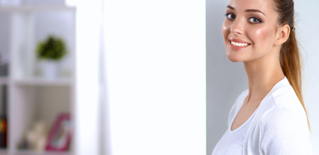 Attractive businesswoman standing  near wall in officeの写真素材