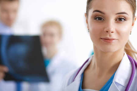 Attractive female doctor in front of medical group .の写真素材