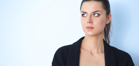 A young woman standing, isolated on graybackgroundの写真素材