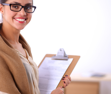 Attractive businesswoman standing near desk in the officeの写真素材