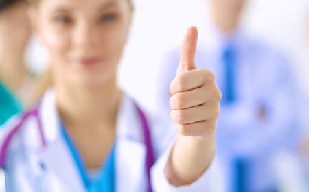 Woman doctor standing with stethoscope at hospital,の写真素材