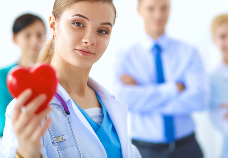 Female doctor with stethoscope holding heart .の写真素材