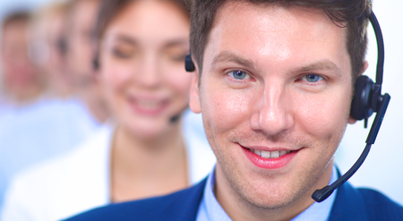 Attractive positive young businesspeople and colleagues in a call center office.の写真素材