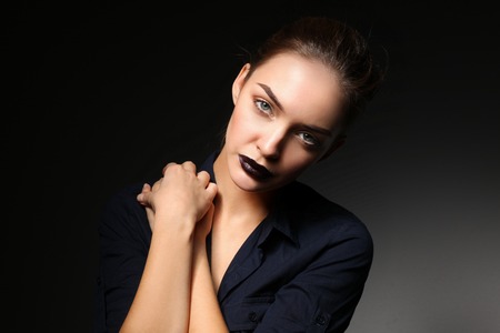 Portrait of beautiful young woman face. Isolated on black background.の写真素材