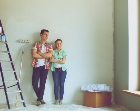Portrait of young couple moving in new home.の写真素材