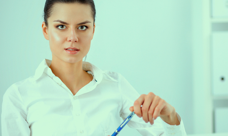 Attractive businesswoman sitting with laptop  in the officeの写真素材