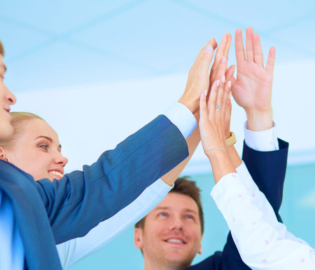 Business people with their hands together in a circle .