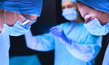 Team surgeon at work in operating roomの写真素材