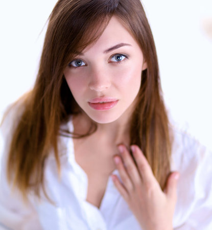 Portrait of beautiful smiling woman on bed at bedroom.の写真素材