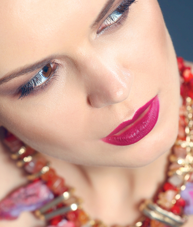 Portrait of young beautiful brunette woman in beads .の写真素材