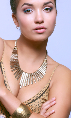 Portrait of young beautiful brunette woman in beads .の写真素材